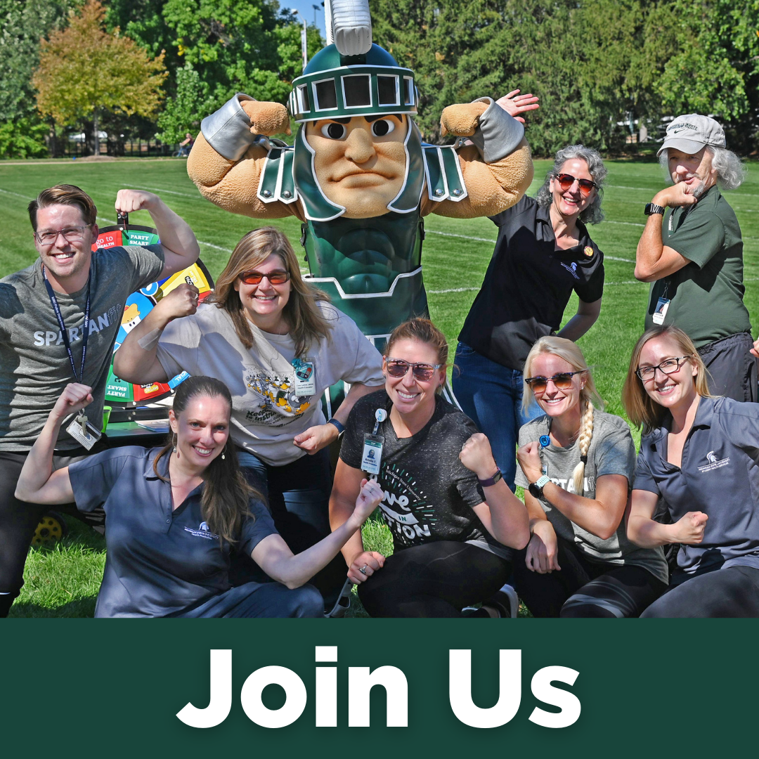 The Health Promotion team poses with Sparty on a sunny day.